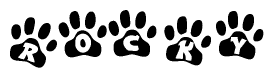 The image shows a row of animal paw prints, each containing a letter. The letters spell out the word Rocky within the paw prints.