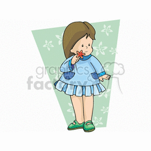 A little girl in a blue dress smelling a flower