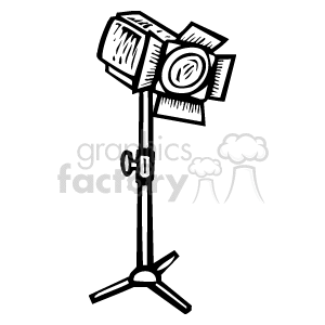 The image is a black and white clipart of a spotlight, which is typical equipment used in theater, movie sets, and musical performances. It appears to represent a stage light on a stand, designed to focus light on a specific area or performer.