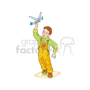 Little boy in yellow bib overalls playing with his toy plane