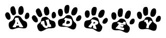 The image shows a series of animal paw prints arranged horizontally. Within each paw print, there's a letter; together they spell Audrey