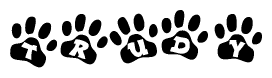 The image shows a row of animal paw prints, each containing a letter. The letters spell out the word Trudy within the paw prints.