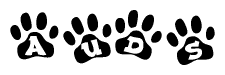 The image shows a series of animal paw prints arranged horizontally. Within each paw print, there's a letter; together they spell Auds