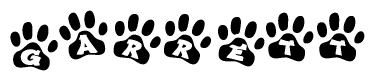 The image shows a row of animal paw prints, each containing a letter. The letters spell out the word Garrett within the paw prints.