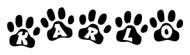 The image shows a series of animal paw prints arranged in a horizontal line. Each paw print contains a letter, and together they spell out the word Karlo.