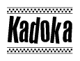 The image is a black and white clipart of the text Kadoka in a bold, italicized font. The text is bordered by a dotted line on the top and bottom, and there are checkered flags positioned at both ends of the text, usually associated with racing or finishing lines.