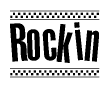 The clipart image displays the text Rockin in a bold, stylized font. It is enclosed in a rectangular border with a checkerboard pattern running below and above the text, similar to a finish line in racing. 