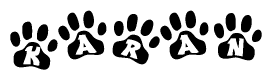 The image shows a series of animal paw prints arranged horizontally. Within each paw print, there's a letter; together they spell Karan