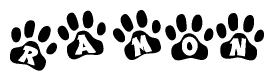 The image shows a row of animal paw prints, each containing a letter. The letters spell out the word Ramon within the paw prints.
