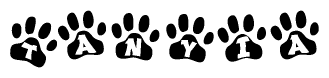 The image shows a row of animal paw prints, each containing a letter. The letters spell out the word Tanyia within the paw prints.