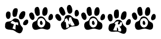 The image shows a row of animal paw prints, each containing a letter. The letters spell out the word Tomoko within the paw prints.