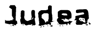 This nametag says Judea, and has a static looking effect at the bottom of the words. The words are in a stylized font.