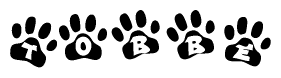 The image shows a row of animal paw prints, each containing a letter. The letters spell out the word Tobbe within the paw prints.