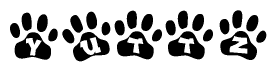 The image shows a row of animal paw prints, each containing a letter. The letters spell out the word Yuttz within the paw prints.