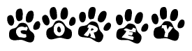 The image shows a row of animal paw prints, each containing a letter. The letters spell out the word Corey within the paw prints.