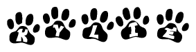 The image shows a row of animal paw prints, each containing a letter. The letters spell out the word Kylie within the paw prints.