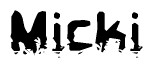 This nametag says Micki, and has a static looking effect at the bottom of the words. The words are in a stylized font.