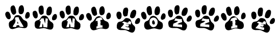 The image shows a row of animal paw prints, each containing a letter. The letters spell out the word Annieozzie within the paw prints.