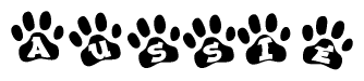 The image shows a row of animal paw prints, each containing a letter. The letters spell out the word Aussie within the paw prints.