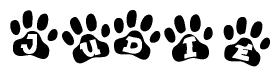 The image shows a row of animal paw prints, each containing a letter. The letters spell out the word Judie within the paw prints.