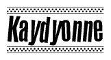 The image is a black and white clipart of the text Kaydyonne in a bold, italicized font. The text is bordered by a dotted line on the top and bottom, and there are checkered flags positioned at both ends of the text, usually associated with racing or finishing lines.