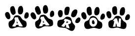 The image shows a row of animal paw prints, each containing a letter. The letters spell out the word Aaron within the paw prints.