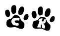 The image shows a row of animal paw prints, each containing a letter. The letters spell out the word Ck within the paw prints.