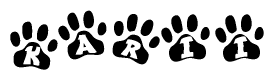 The image shows a row of animal paw prints, each containing a letter. The letters spell out the word Karii within the paw prints.