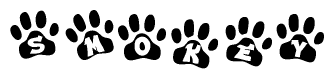 The image shows a series of animal paw prints arranged horizontally. Within each paw print, there's a letter; together they spell Smokey