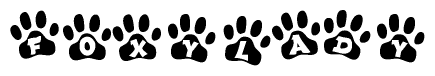 The image shows a series of animal paw prints arranged in a horizontal line. Each paw print contains a letter, and together they spell out the word Foxylady.