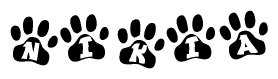 The image shows a series of animal paw prints arranged in a horizontal line. Each paw print contains a letter, and together they spell out the word Nikia.
