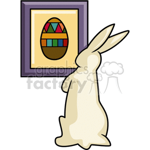 Tan Easter rabbit staring at egg painting