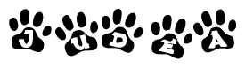 The image shows a row of animal paw prints, each containing a letter. The letters spell out the word Judea within the paw prints.