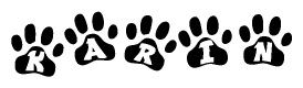 The image shows a series of animal paw prints arranged in a horizontal line. Each paw print contains a letter, and together they spell out the word Karin.